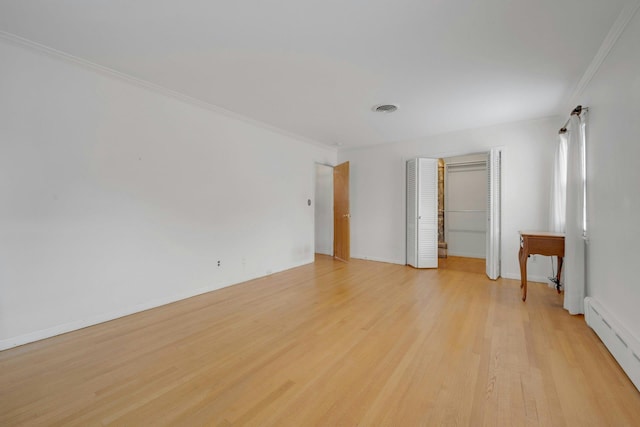 115 Fowler Ave, Yonkers, NY 10701 - spare room with a baseboard heating unit, ornamental molding, light wood-style floors, and baseboards