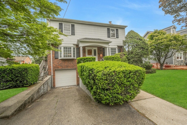 115 Fowler Ave, Yonkers, NY 10701 - traditional-style home with brick siding, concrete driveway, a front yard, a garage, and stairs