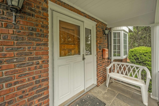 115 Fowler Ave, Yonkers, NY 10701 - doorway to property featuring brick siding and a porch