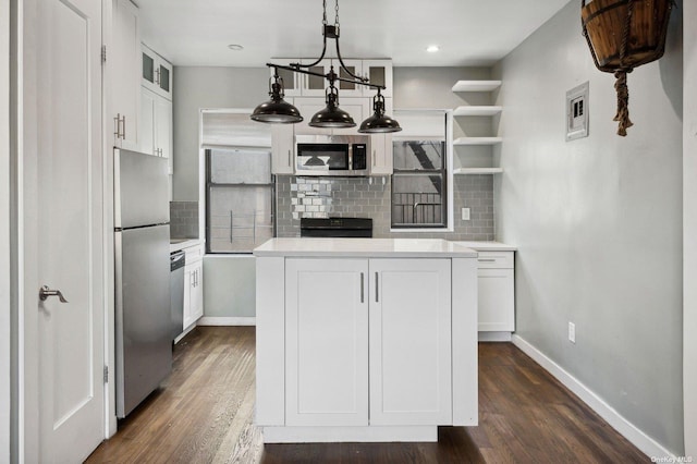 21-16 35th St Unit 5B, Astoria, NY 11105 - kitchen with stainless steel appliances, baseboards, tasteful backsplash, dark wood finished floors, and white cabinetry