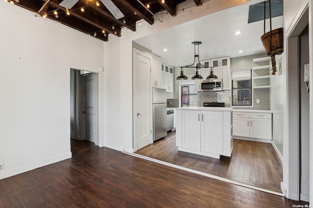 21-16 35th St Unit 5B, Astoria, NY 11105 - kitchen featuring appliances with stainless steel finishes, beam ceiling, white cabinetry, light countertops, and a kitchen island