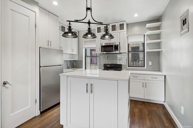 21-16 35th St Unit 5B, Astoria, NY 11105 - kitchen featuring stainless steel appliances, a sink, tasteful backsplash, white cabinets, and recessed lighting