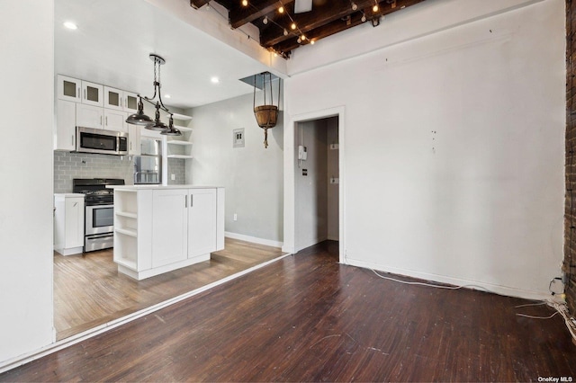 21-16 35th St Unit 5B, Astoria, NY 11105 - kitchen featuring appliances with stainless steel finishes, open shelves, white cabinetry, dark wood-style floors, and decorative backsplash