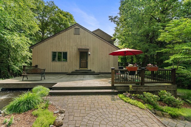 20 Old Farm Ln, Garrison, NY 10524 - view of front of house featuring a wooden deck and outdoor dining area