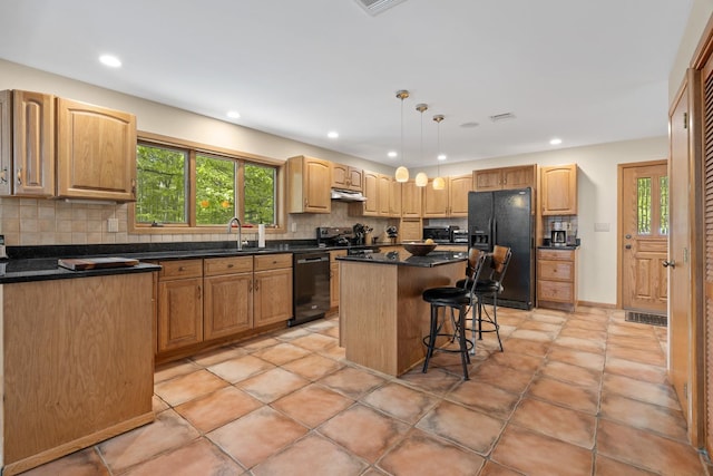 20 Old Farm Ln, Garrison, NY 10524 - kitchen with black appliances, under cabinet range hood, tasteful backsplash, healthy amount of natural light, and recessed lighting