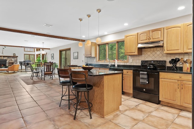 20 Old Farm Ln, Garrison, NY 10524 - kitchen with black electric range oven, under cabinet range hood, tasteful backsplash, a breakfast bar, and a kitchen island