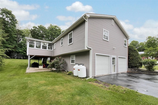 20 Shale Dr, Wappingers Falls, NY 12590 - view of side of home featuring driveway, an attached garage, a yard, and a sunroom