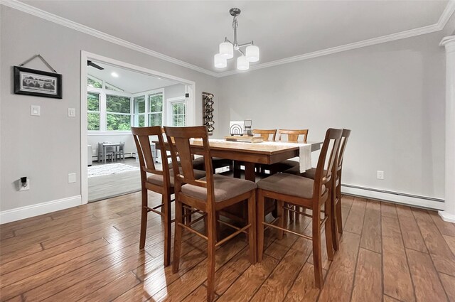 20 Shale Dr, Wappingers Falls, NY 12590 - dining area featuring a baseboard heating unit, wood-type flooring, a chandelier, crown molding, and baseboards