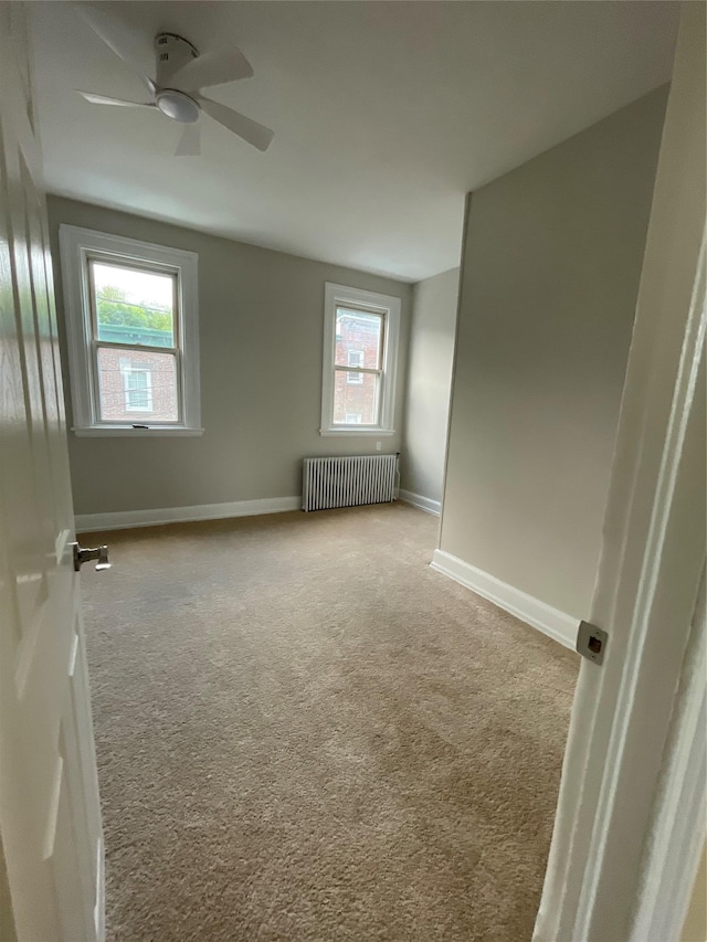 32 Moquette Row S, Yonkers, NY 10703 - carpeted empty room featuring radiator, baseboards, and ceiling fan