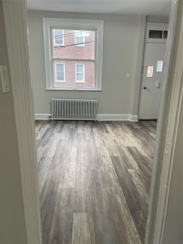 32 Moquette Row S, Yonkers, NY 10703 - spare room with radiator, dark wood finished floors, and baseboards