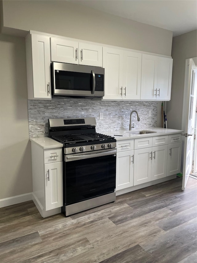 32 Moquette Row S, Yonkers, NY 10703 - kitchen with stainless steel appliances, a sink, light countertops, and decorative backsplash