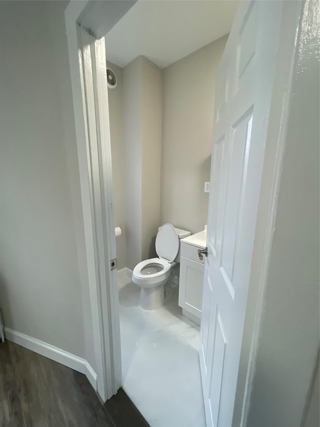 32 Moquette Row S, Yonkers, NY 10703 - bathroom with baseboards, toilet, vanity, and wood finished floors