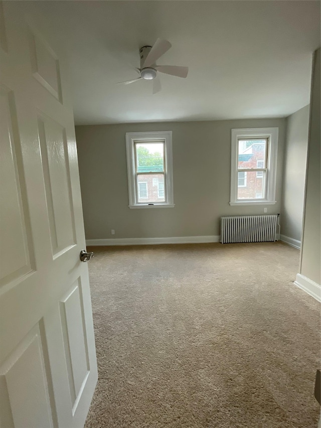 32 Moquette Row S, Yonkers, NY 10703 - unfurnished room featuring radiator, carpet, plenty of natural light, and baseboards