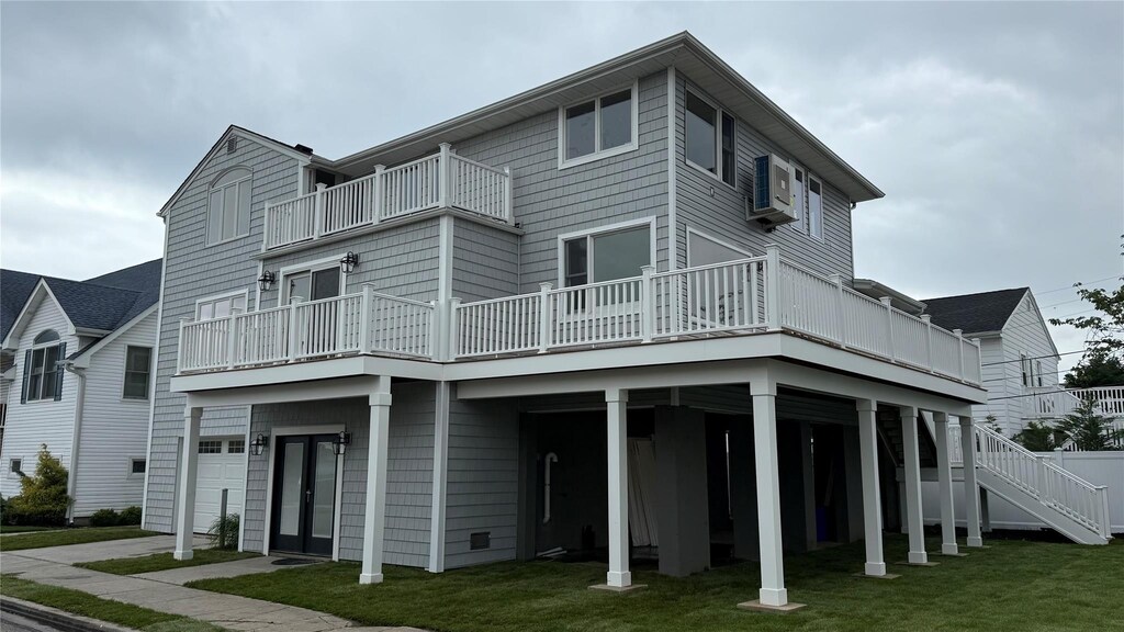 85 Dalton St, Long Beach, NY 11561 - back of property with a balcony, a lawn, and a garage