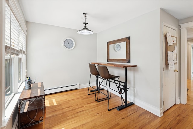 17 Tulip Rd, Rocky Point, NY 11778 - dining room with baseboard heating, light wood-style floors, and baseboards