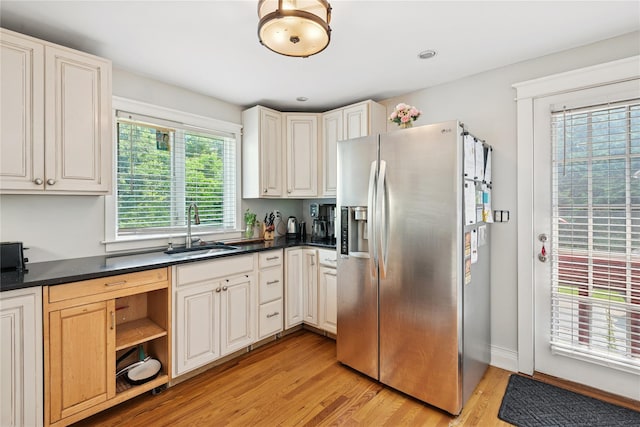 17 Tulip Rd, Rocky Point, NY 11778 - kitchen with stainless steel refrigerator with ice dispenser, a sink, light wood finished floors, dark countertops, and open shelves