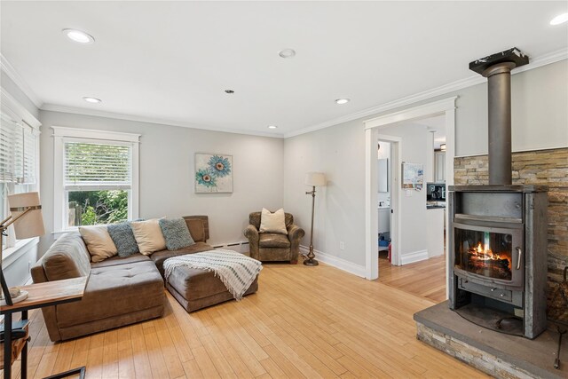 17 Tulip Rd, Rocky Point, NY 11778 - living room with a wood stove, a baseboard radiator, light wood-style floors, recessed lighting, and ornamental molding