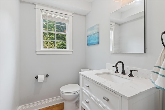 17 Tulip Rd, Rocky Point, NY 11778 - bathroom featuring vanity, toilet, wood finished floors, and baseboards