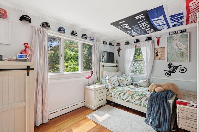 17 Tulip Rd, Rocky Point, NY 11778 - bedroom with a baseboard radiator, light wood-type flooring, and crown molding