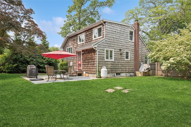 17 Tulip Rd, Rocky Point, NY 11778 - rear view of house with a chimney and a patio area
