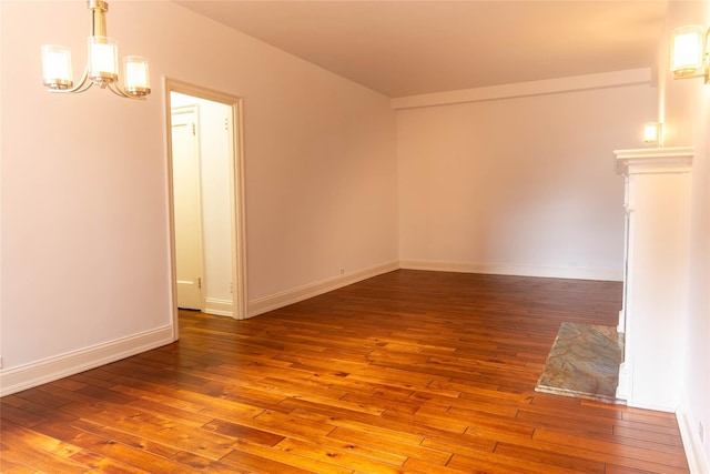 8 Barstow Rd Unit 4F, Great Neck, NY 11021 - spare room with a chandelier, hardwood / wood-style floors, and baseboards