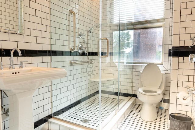 8 Barstow Rd Unit 4F, Great Neck, NY 11021 - bathroom with tile walls, toilet, a shower stall, tile patterned floors, and decorative backsplash