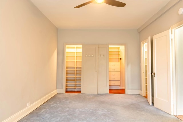 8 Barstow Rd Unit 4F, Great Neck, NY 11021 - unfurnished bedroom with a walk in closet, carpet flooring, baseboards, a closet, and a ceiling fan