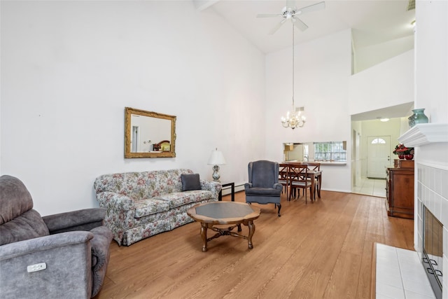 30 Joyces Way, Bay Shore, NY 11706 - living area featuring light wood-style flooring, a chandelier, ceiling fan, high vaulted ceiling, and a baseboard radiator