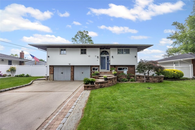 24 Sugarwood Ln, Commack, NY 11725 - bi-level home featuring a garage, driveway, and brick siding