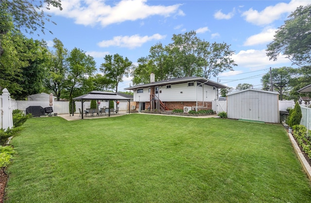 24 Sugarwood Ln, Commack, NY 11725 - rear view of property featuring a gazebo, a chimney, brick siding, and a patio area