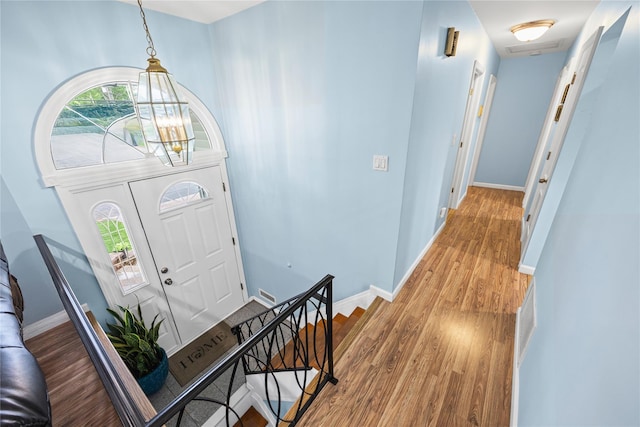 24 Sugarwood Ln, Commack, NY 11725 - foyer featuring a chandelier, light wood-style floors, and baseboards