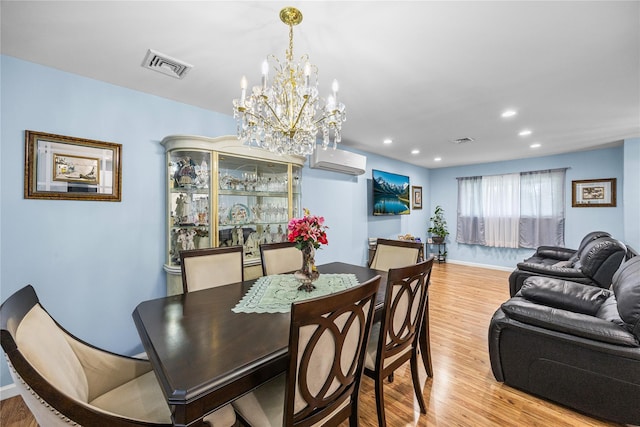 24 Sugarwood Ln, Commack, NY 11725 - dining space featuring light wood-style flooring, a wall mounted air conditioner, a chandelier, recessed lighting, and baseboards