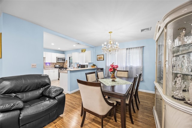 24 Sugarwood Ln, Commack, NY 11725 - dining room with a chandelier, light wood finished floors, baseboards, and recessed lighting
