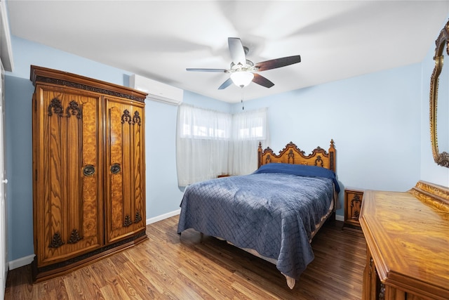 24 Sugarwood Ln, Commack, NY 11725 - bedroom with a wall unit AC, wood finished floors, a ceiling fan, and baseboards