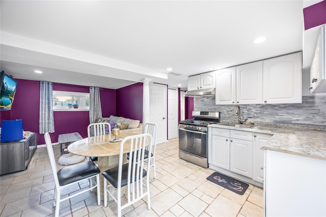 24 Sugarwood Ln, Commack, NY 11725 - kitchen with stainless steel range with gas cooktop, under cabinet range hood, tasteful backsplash, recessed lighting, and white cabinetry