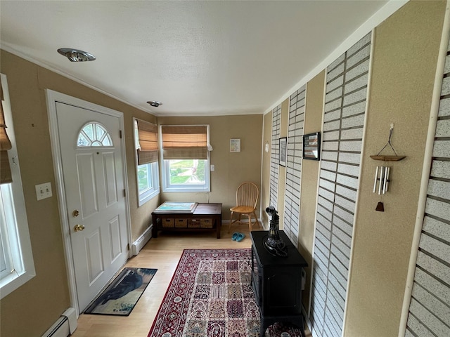 42 Saint Marks Ave, Freeport, NY 11520 - foyer entrance with a baseboard radiator, wood finished floors, ornamental molding, and baseboards