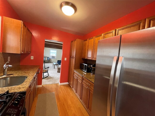 42 Saint Marks Ave, Freeport, NY 11520 - kitchen featuring appliances with stainless steel finishes, a sink, light wood-type flooring, and decorative backsplash