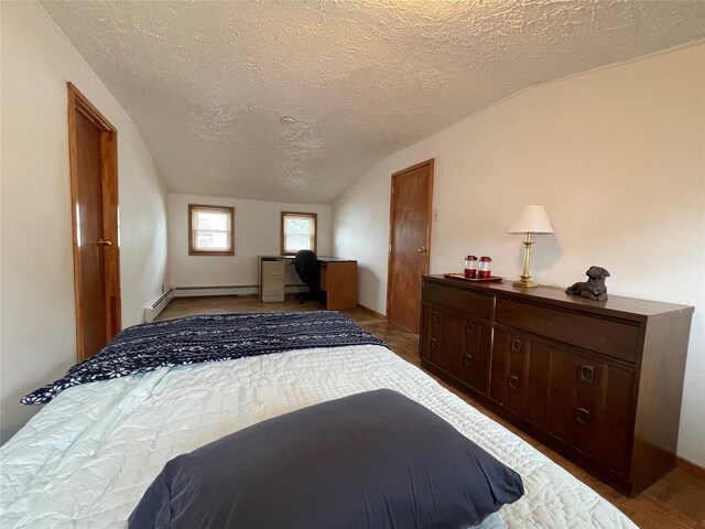 42 Saint Marks Ave, Freeport, NY 11520 - bedroom featuring lofted ceiling, a baseboard radiator, and a textured ceiling