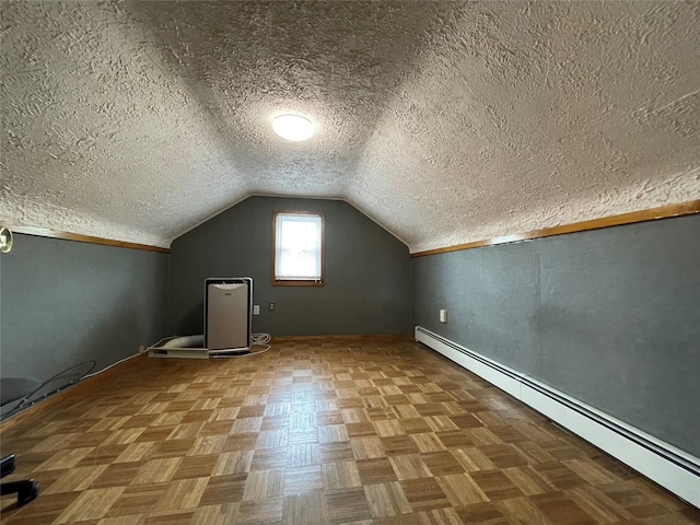 42 Saint Marks Ave, Freeport, NY 11520 - bonus room with a baseboard radiator, a textured ceiling, vaulted ceiling, and baseboards