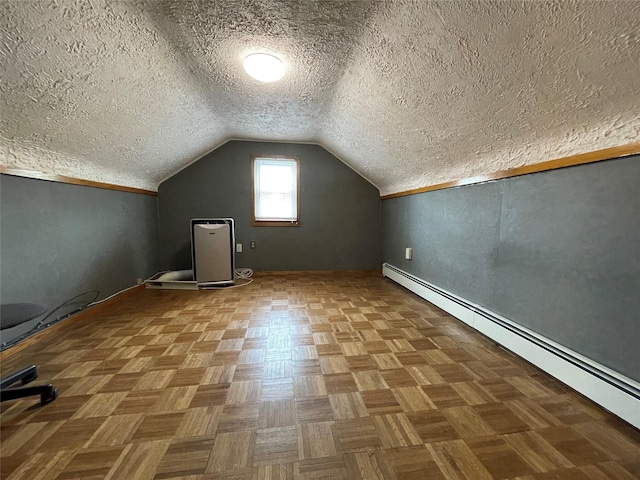 42 Saint Marks Ave, Freeport, NY 11520 - bonus room with baseboard heating, a textured ceiling, vaulted ceiling, and baseboards