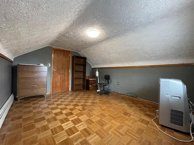 42 Saint Marks Ave, Freeport, NY 11520 - bonus room featuring a baseboard radiator, a textured ceiling, baseboards, and lofted ceiling