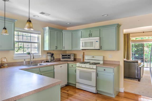 17 Gettysburg Dr Unit 17, Port Jefferson Station, NY 11776 - kitchen featuring white appliances, a sink, green cabinets, pendant lighting, and light wood finished floors