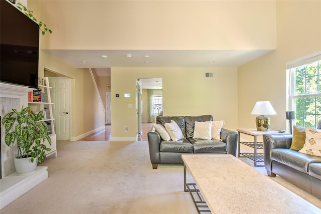 17 Gettysburg Dr Unit 17, Port Jefferson Station, NY 11776 - living room with light colored carpet, a towering ceiling, stairs, baseboards, and recessed lighting