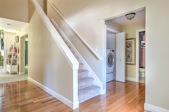 17 Gettysburg Dr Unit 17, Port Jefferson Station, NY 11776 - stairs featuring wood finished floors, washer / clothes dryer, and baseboards