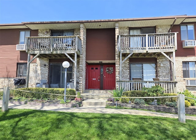 263 River Ave Unit 52, Patchogue, NY 11772 - view of front facade with a balcony and brick siding