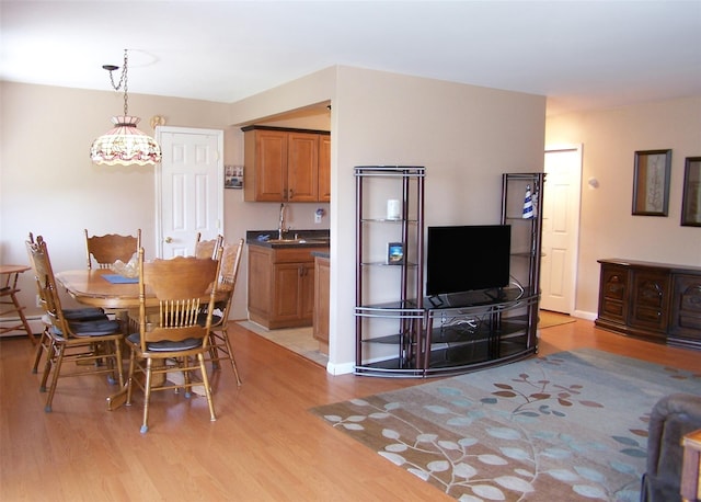 263 River Ave Unit 52, Patchogue, NY 11772 - dining area with light wood-type flooring and baseboards
