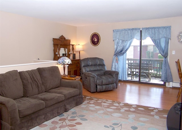 263 River Ave Unit 52, Patchogue, NY 11772 - living area with wood finished floors and a baseboard heating unit
