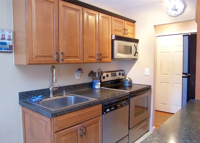 263 River Ave Unit 52, Patchogue, NY 11772 - kitchen featuring stainless steel appliances, a sink, and dark countertops