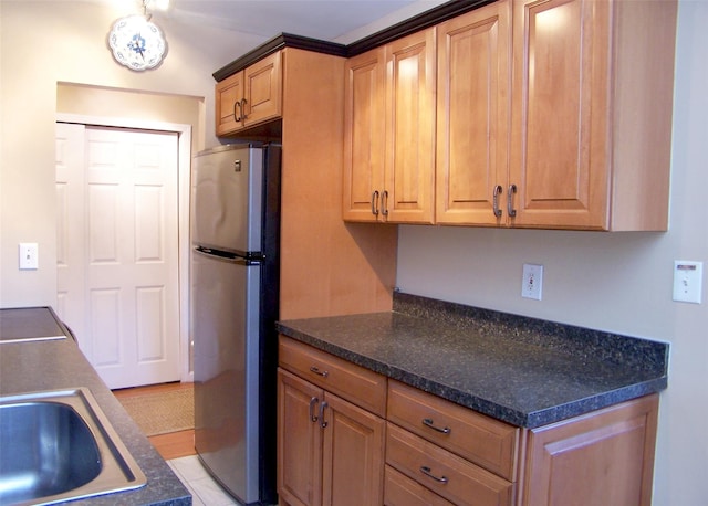 263 River Ave Unit 52, Patchogue, NY 11772 - kitchen with freestanding refrigerator and dark countertops
