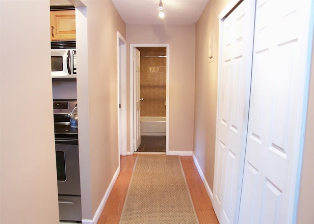 263 River Ave Unit 52, Patchogue, NY 11772 - corridor with light wood-style flooring and baseboards
